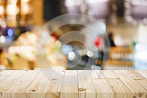Wooden table with blur background of coffee shop