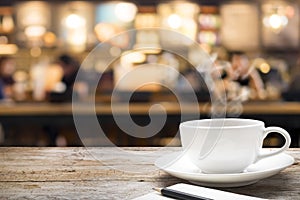 Wooden table with blur background of coffee shop