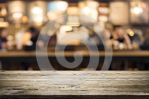 Wooden table with blur background of coffee shop