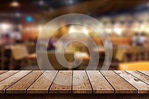 Wooden table in blur resturant background photo