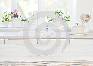 Wooden table on blurred background of kitchen blurred sink window