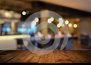 Wooden table with blurred cafe restaurant