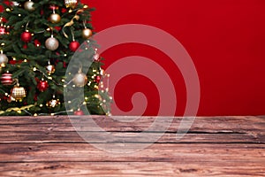 Wooden table and blurred Christmas tree with fairy lights