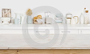 Wooden table on blurred kitchen counter background with cooking ingredients