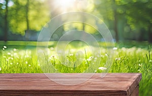 wooden table and blurred natural background grass and flowers