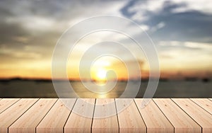 wooden table with blurred sea before sunset with clouds on background - For product display.
