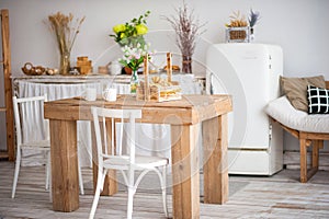 Wooden table in a bright rustic-style kitchen. Scandinavian style in the int