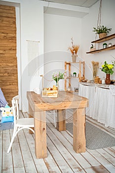 Wooden table in a bright rustic-style kitchen. Scandinavian style in the int