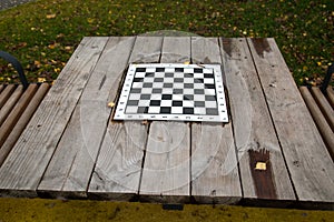 Wooden table with built-in chess Board on the alley in the city outdoors. Sport is a healthy lifestyle