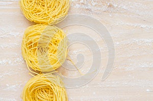 Wooden table with capelli d'angelo pasta photo
