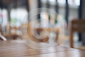 Wooden table and chair in cafe with blur bokeh abstract