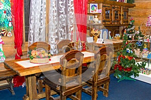 Wooden table and chairs in a christmas decorated room