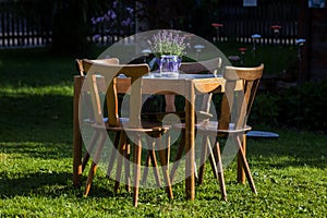Wooden table with chairs in the garden