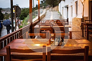 Wooden table and chairs. Outdoor cafe with wooden tables. Natural tables near a street cafe on a summer day