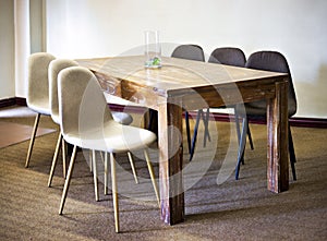 wooden table and chairs presented in a small and simple flat