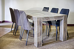 wooden table and chairs presented in a small and simple flat