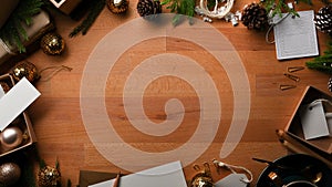 Wooden table with copy space, mock up greeting card and decorations in Christmas concept