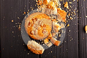 On the wooden table are crumbs from oatmeal cookies. Inside.