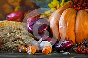 The wooden table decorated with vegetables, pumpkins and autumn leaves. Autumn background. Schastlivy von Thanksgiving