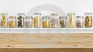 Wooden table on defocused background of groceries in glass jars