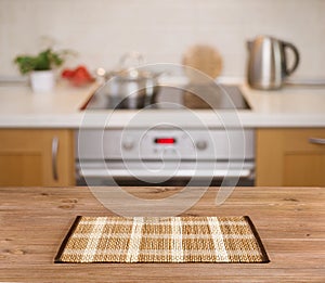 Wooden table on defocused kitchen bench background