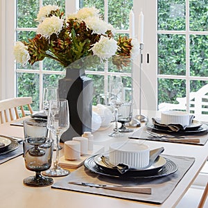 Wooden table in dining room with elegant table setting