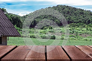 A wooden table for displaying products with a natural background next to the mountains.