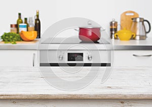 Wooden table in focus on blurred white kitchen interior background