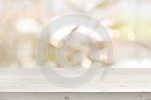 Wooden table in front of abstract blurred summer lights background