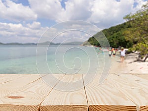 wooden table in front of abstract blurred in view of the sea background