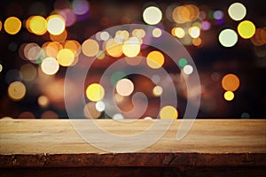 wooden table in front of abstract restaurant lights background