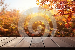 Wooden table in front of blurred autumn leaves background. Ready for product display montage.