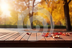 Wooden table in front of blurred autumn leaves background. Ready for product display montage.