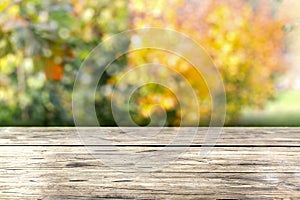 Wooden table in front of colorful autumn landscape