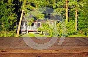 wooden table in front green forest trees landscape background. for product display and presentation