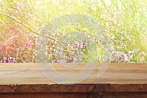 wooden table in front of spring cherry tree.