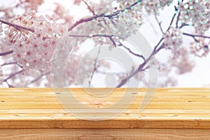 wooden table in front of white cherry tree