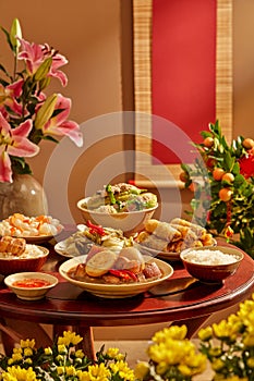 A wooden table full of Vietnamese traditional dishes commonly encountered on Tet holiday