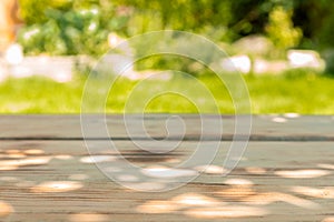 Wooden table in a garden in a sunny day