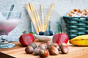 Summer meal with yogurt, strawberries, hazelnuts and pastery