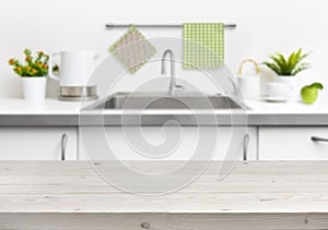 Wooden table on kitchen sink interior background