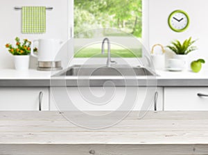 Wooden table on kitchen sink window background photo