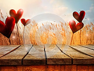 Wooden table with landscape and hearts. Valentines background