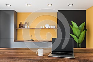 Computer in yellow and gray kitchen