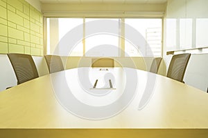 Wooden table in meeting room with sound absorbers sunlight from windows