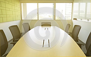 Wooden table in meeting room with sound absorbing wall sunlight through windows