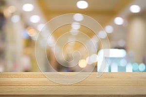 Wooden table with montage blurred shopping mall background