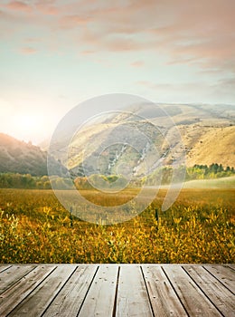 Wooden table with mountains in background