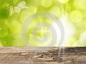 Wooden Table and Nature Background with Green Leaves and Sun