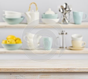 Wooden table over background of shelves with kitchenware